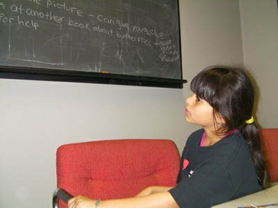 Arianny reads from the blackboard