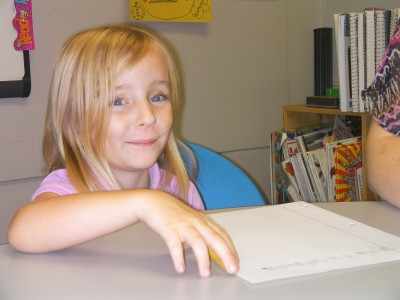Hannah smiles as she writes